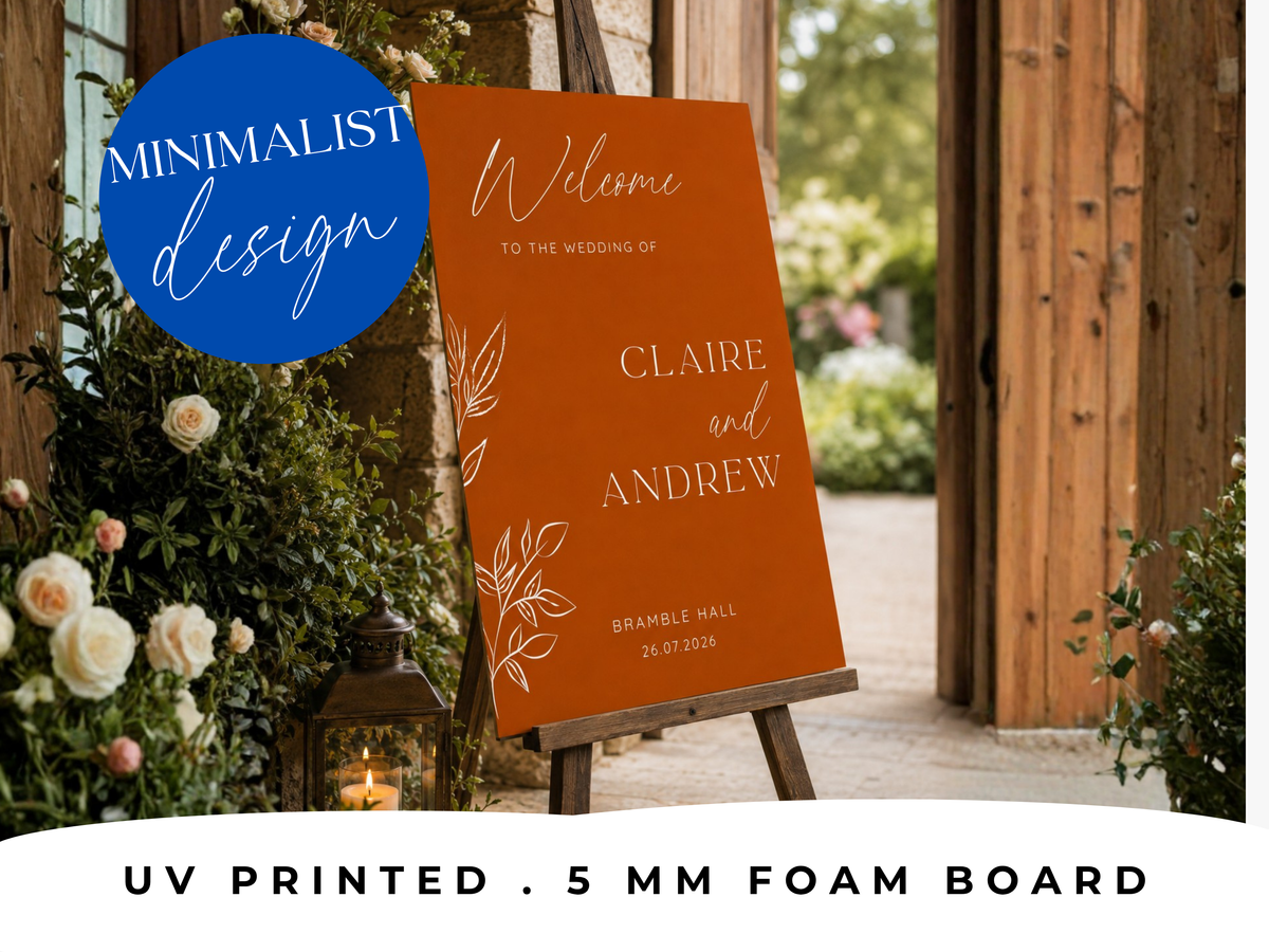 Close-up of burnt orange wedding welcome sign showing modern script typography