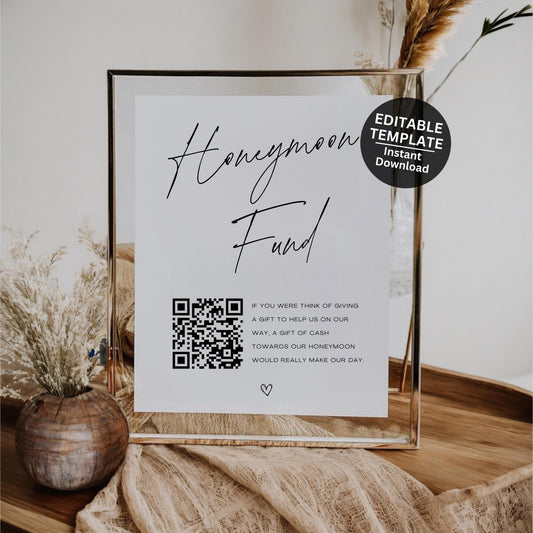Boho honeymoon fund sign printable displayed in wooden frame at neutral wedding reception