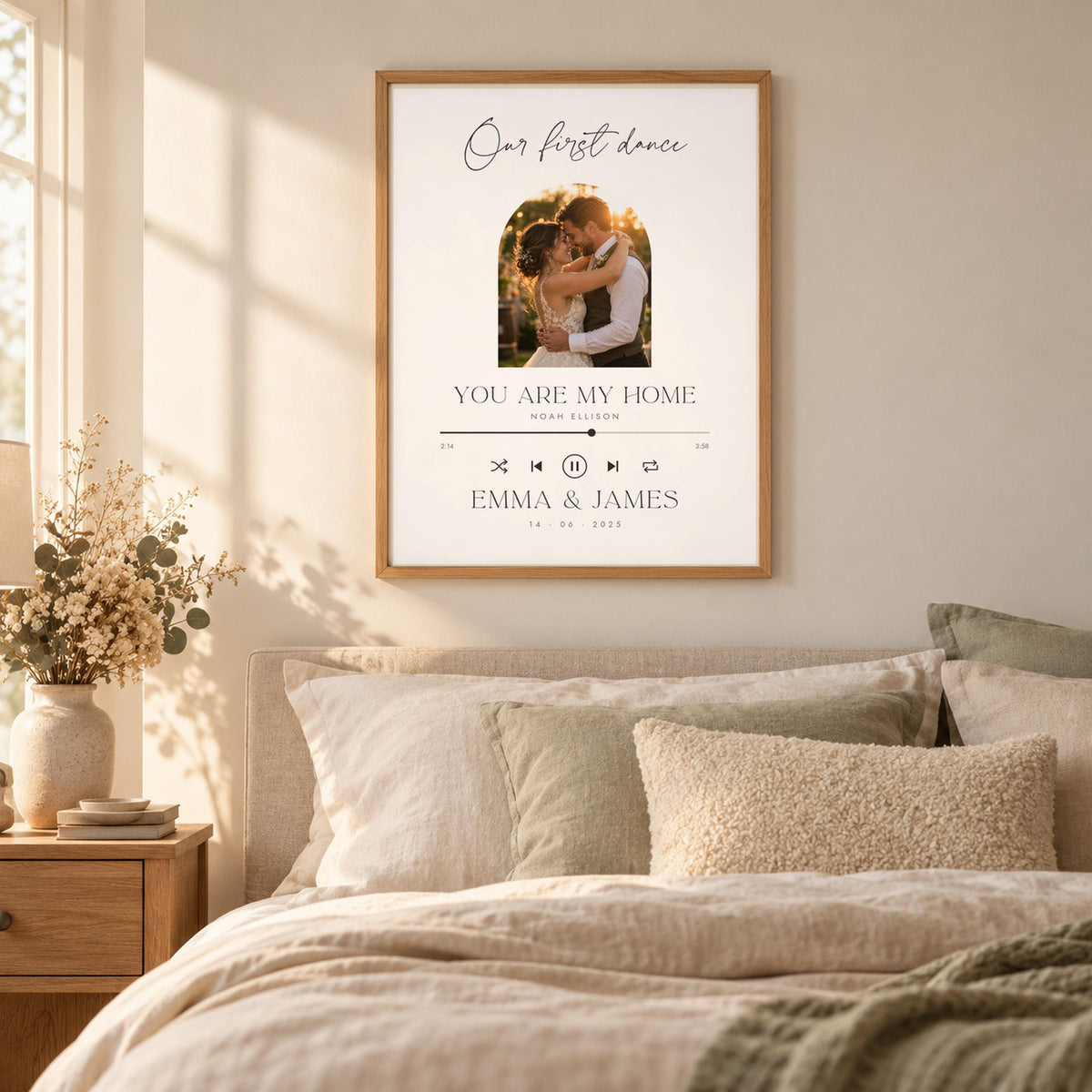 First dance song print framed above a bed in a neutral bedroom